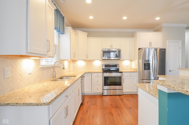 kitchen with white cabinetry, sink, crown molding, and appliances with stainless steel finishes