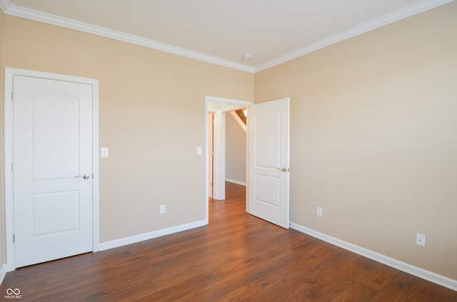 unfurnished bedroom with dark hardwood / wood-style flooring and ornamental molding