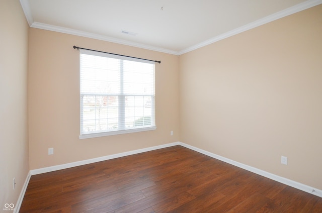 spare room with crown molding and dark wood-type flooring