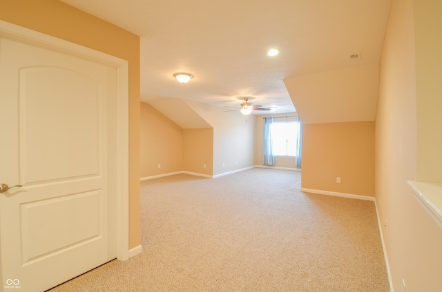 bonus room with ceiling fan and carpet floors