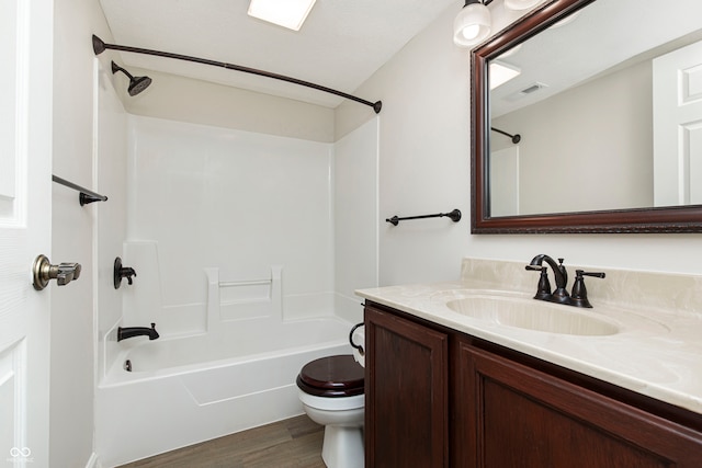 full bathroom with toilet, vanity, bathing tub / shower combination, and wood-type flooring