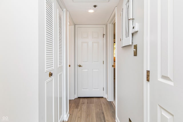 hallway with light hardwood / wood-style flooring