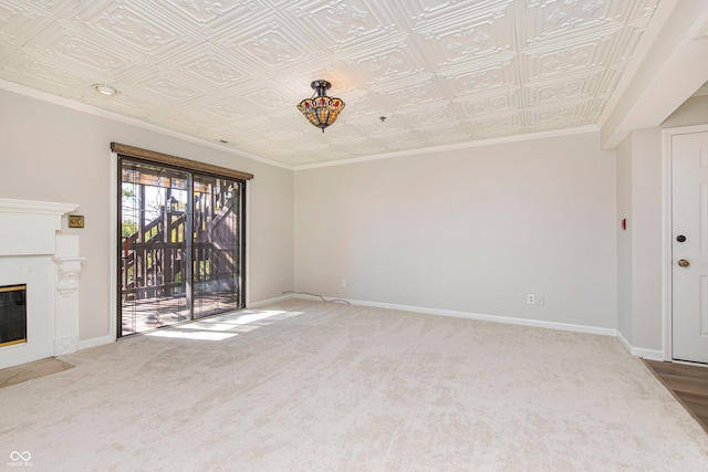 unfurnished living room with ornamental molding and carpet floors