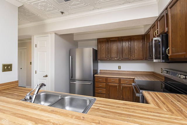 8168 Shorewalk Dr Unit A, Indianapolis, IN 46236 - kitchen with wood finished floors, butcher block countertops, an ornate ceiling, a sink, and stainless steel appliances
