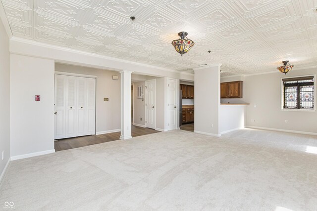 8168 Shorewalk Dr Unit A, Indianapolis, IN 46236 - unfurnished living room with carpet flooring, baseboards, decorative columns, and an ornate ceiling