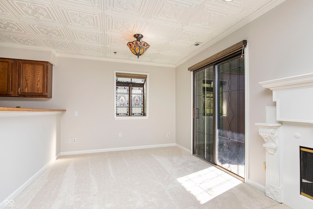 interior space with ornamental molding, a fireplace, and light colored carpet