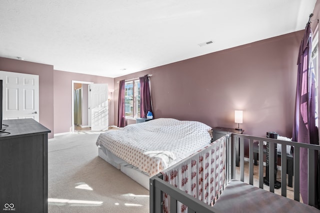 bedroom with a textured ceiling and carpet