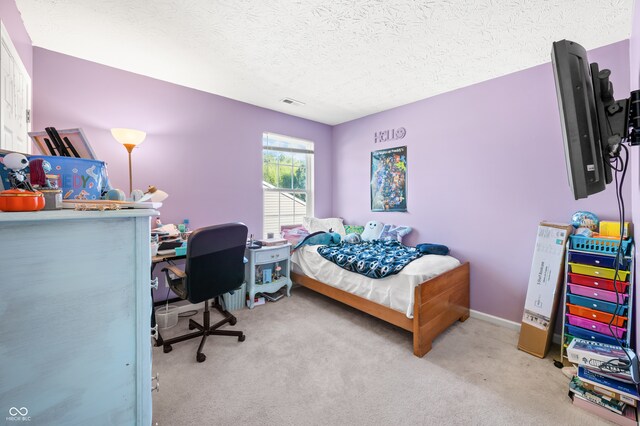 carpeted bedroom with a textured ceiling