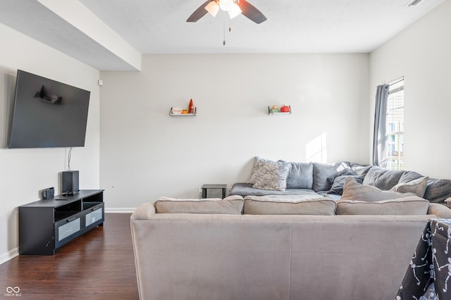 living room featuring dark hardwood / wood-style floors, a textured ceiling, and ceiling fan