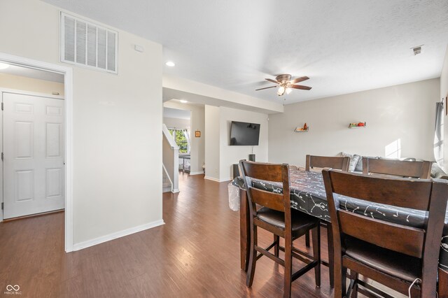 dining area featuring ceiling fan and dark hardwood / wood-style flooring