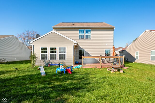 back of house featuring a yard and a deck