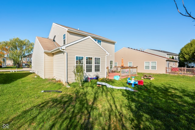 rear view of house with a patio area, a deck, and a lawn