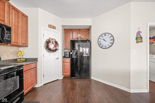 kitchen with washer / dryer, black appliances, a textured ceiling, decorative backsplash, and dark hardwood / wood-style floors