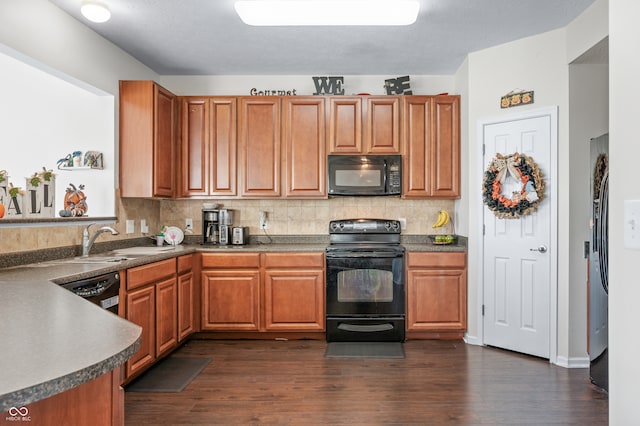 kitchen featuring decorative backsplash, dark wood-type flooring, black appliances, and sink