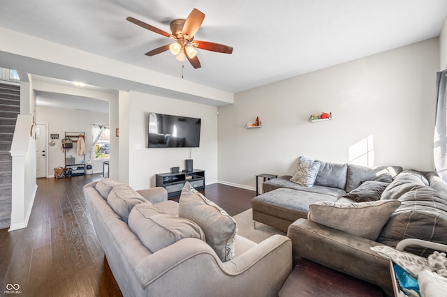 living room with ceiling fan and dark hardwood / wood-style flooring