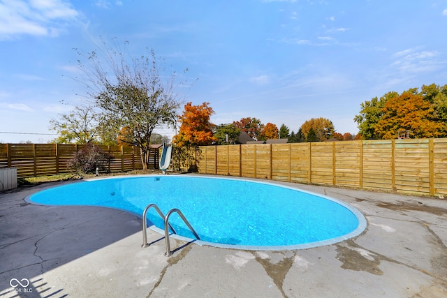 view of swimming pool with a water slide