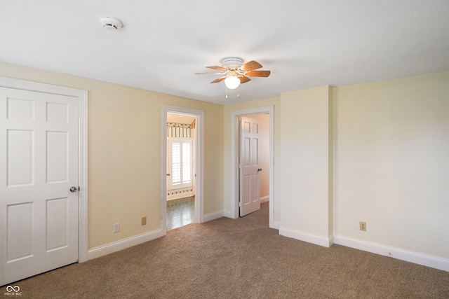 unfurnished room with carpet and ceiling fan