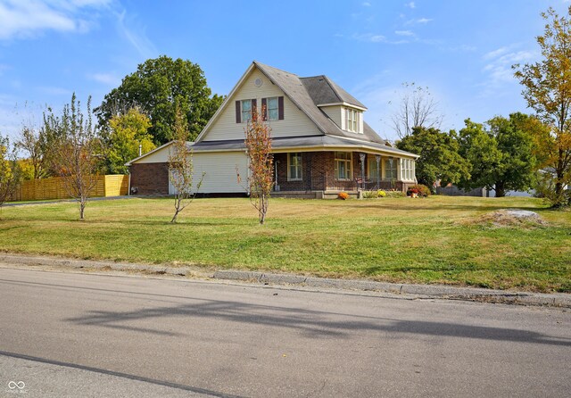 232 N Church St, Morgantown, IN 46160 - view of front facade featuring a front lawn, fence, and covered porch