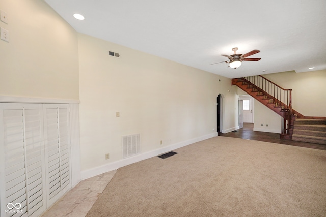 unfurnished living room with ceiling fan and carpet floors