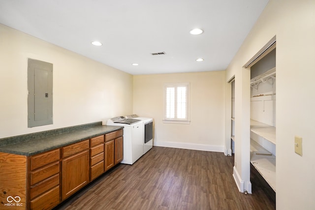 washroom with cabinets, dark wood-type flooring, independent washer and dryer, and electric panel