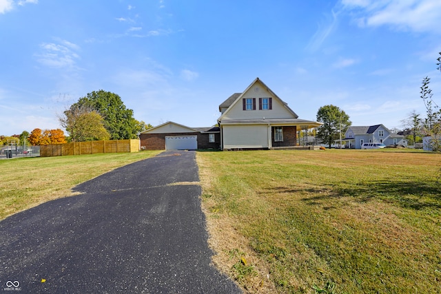 view of front of property featuring a front lawn and a garage