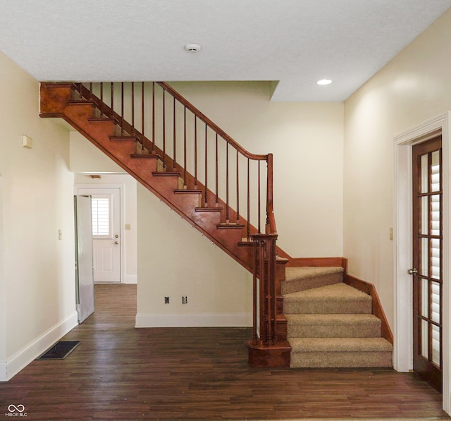 stairs with hardwood / wood-style floors