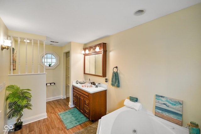 232 N Church St, Morgantown, IN 46160 - full bathroom with baseboards, wood finished floors, a jetted tub, and vanity