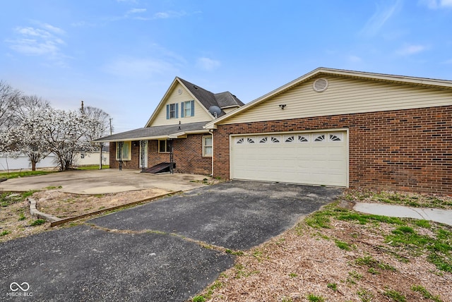 232 N Church St, Morgantown, IN 46160 - view of front of property featuring an attached garage, aphalt driveway, and brick siding