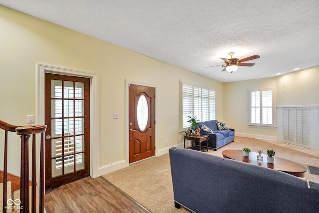 232 N Church St, Morgantown, IN 46160 - carpeted living area with a textured ceiling, baseboards, visible vents, a ceiling fan, and wood finished floors