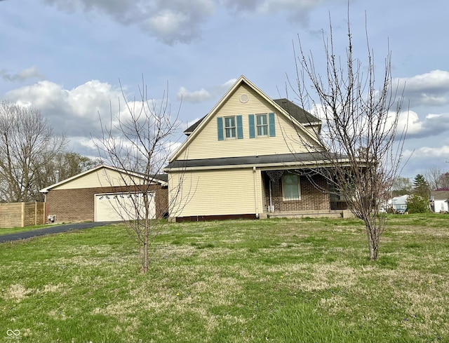 232 N Church St, Morgantown, IN 46160 - view of front of home with a front lawn, fence, brick siding, a garage, and aphalt driveway