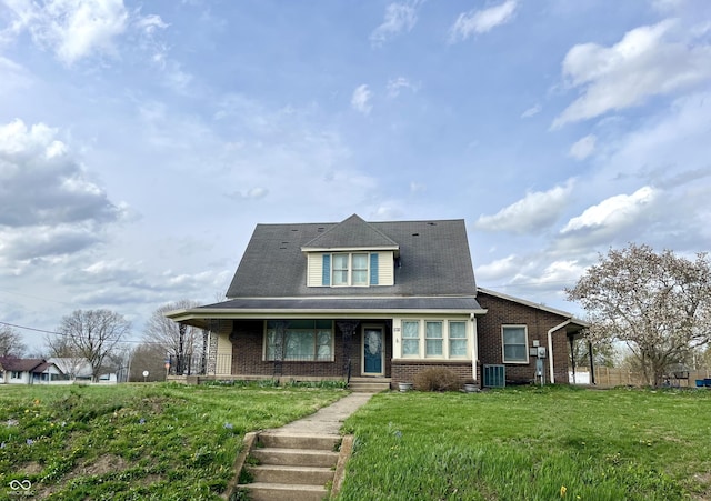 232 N Church St, Morgantown, IN 46160 - view of front of home with central air condition unit, a front lawn, brick siding, and a porch