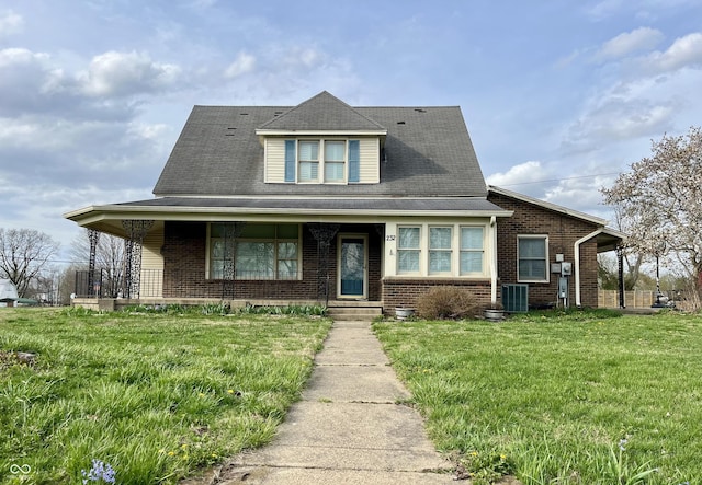232 N Church St, Morgantown, IN 46160 - view of front of home with brick siding, a porch, a front lawn, and central AC unit