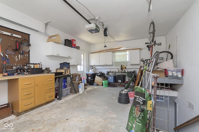 garage with a workshop area and a garage door opener