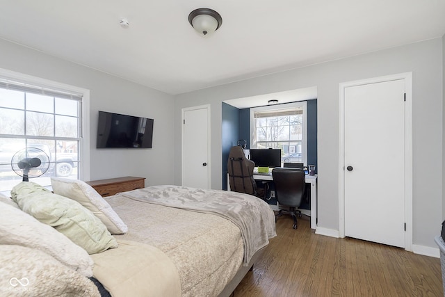 bedroom with baseboards and wood finished floors