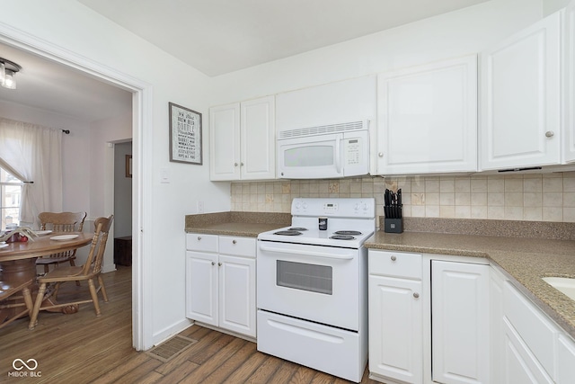 kitchen featuring white appliances, visible vents, dark wood finished floors, white cabinets, and tasteful backsplash