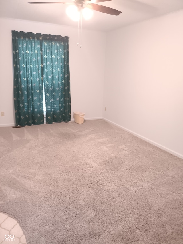 empty room featuring carpet flooring and ceiling fan