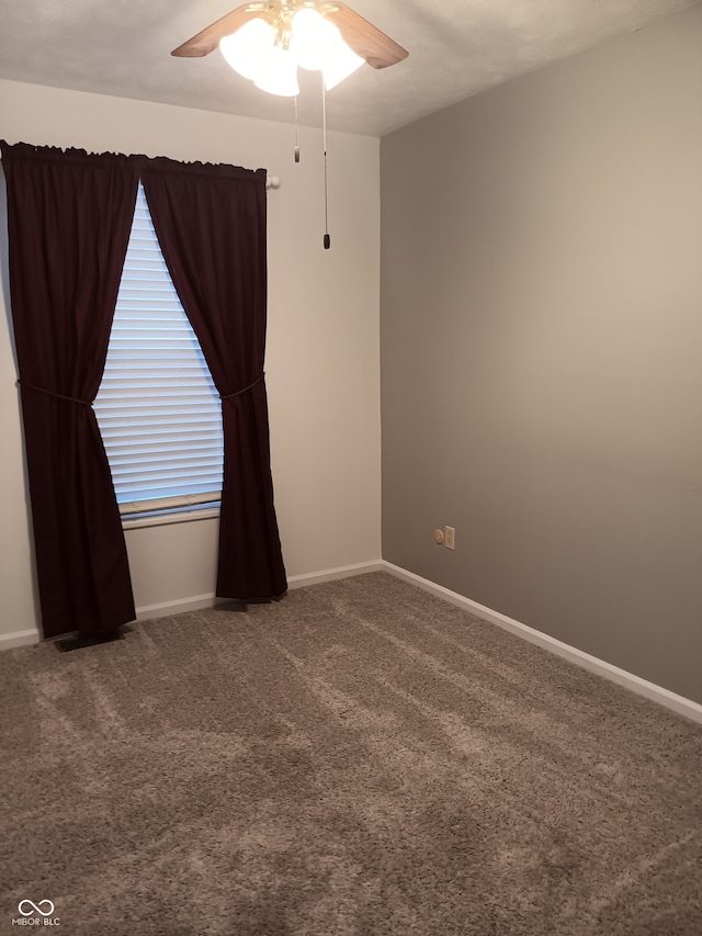 carpeted empty room featuring ceiling fan