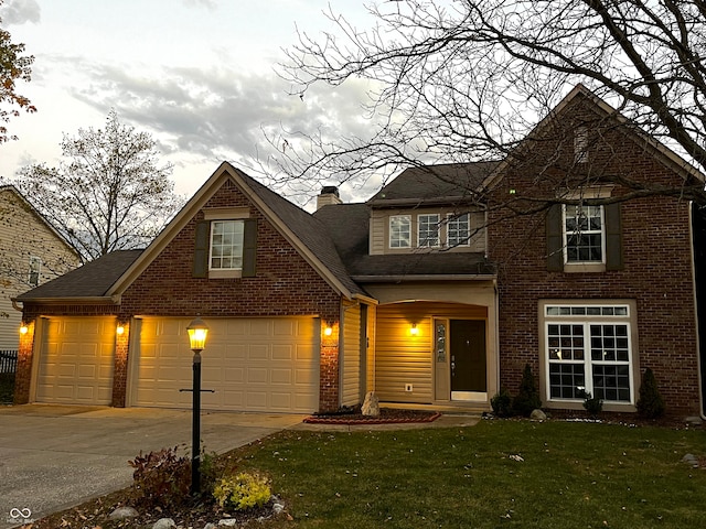 view of front facade with a garage and a front lawn