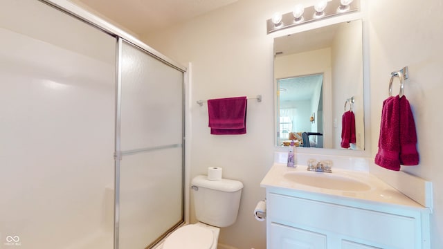 bathroom with vanity, toilet, and walk in shower