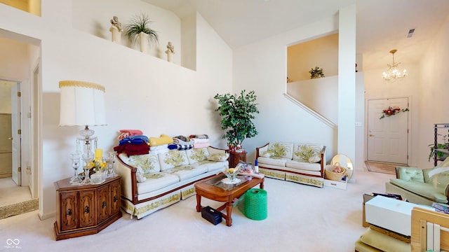 living room with a notable chandelier, carpet floors, and high vaulted ceiling