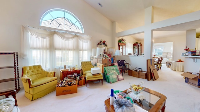 carpeted living room featuring high vaulted ceiling