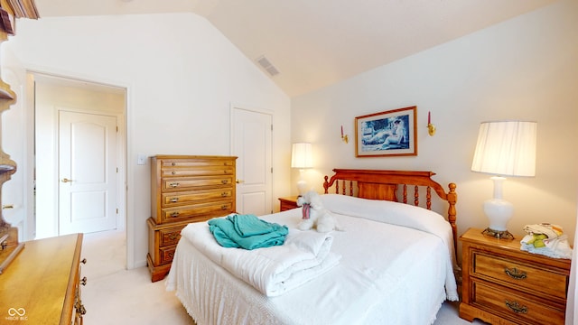 bedroom featuring lofted ceiling and light colored carpet