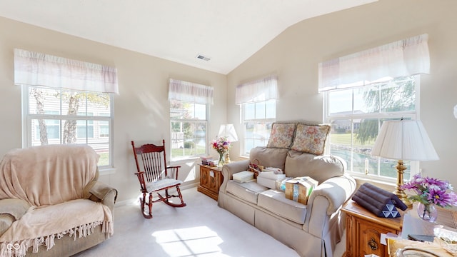 living area featuring lofted ceiling and light carpet