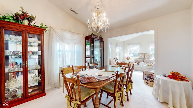 dining space with light carpet, plenty of natural light, and vaulted ceiling