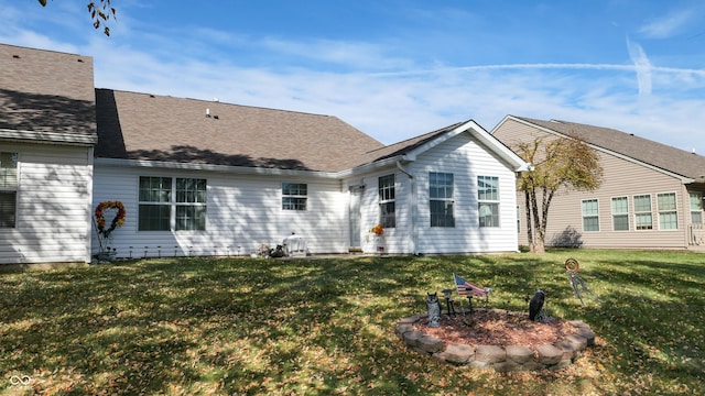 rear view of house featuring a lawn