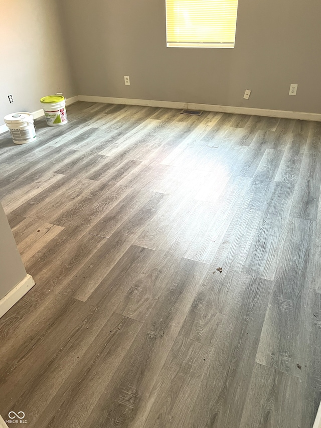 empty room featuring dark wood-type flooring