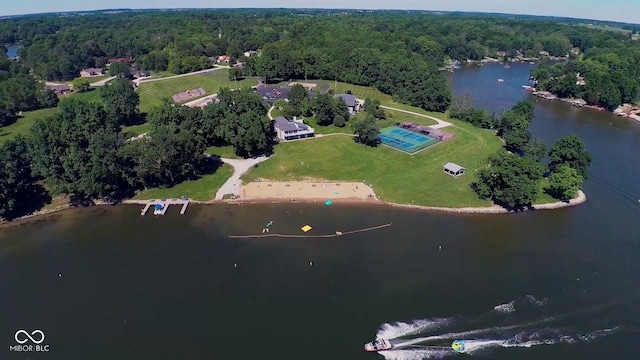 aerial view featuring a wooded view and a water view