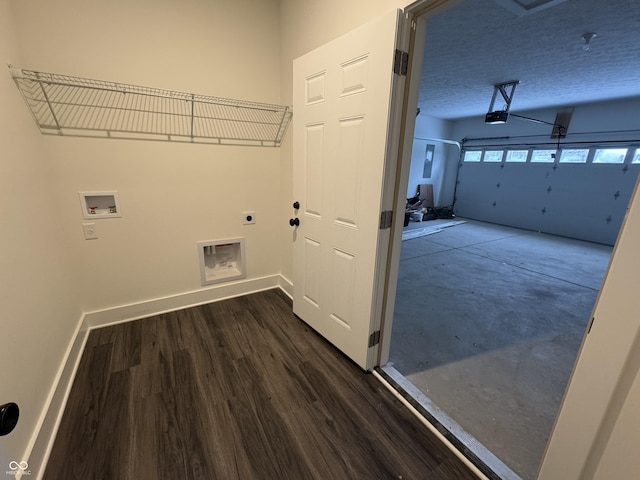 washroom featuring a textured ceiling, a garage, baseboards, hookup for an electric dryer, and hookup for a washing machine