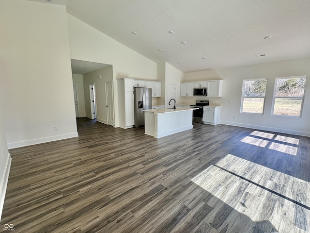 unfurnished living room with baseboards, high vaulted ceiling, and dark wood finished floors