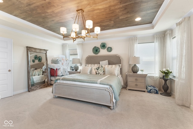 carpeted bedroom featuring a notable chandelier, wooden ceiling, a tray ceiling, and crown molding